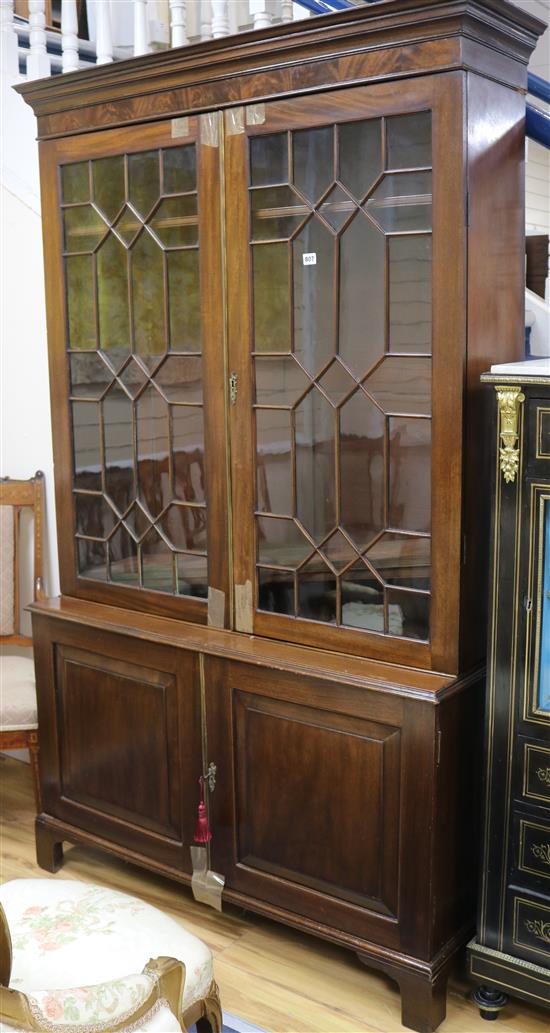 A large mahogany bookcase with double astragal glazed doors and cupboard beneath W.125cm